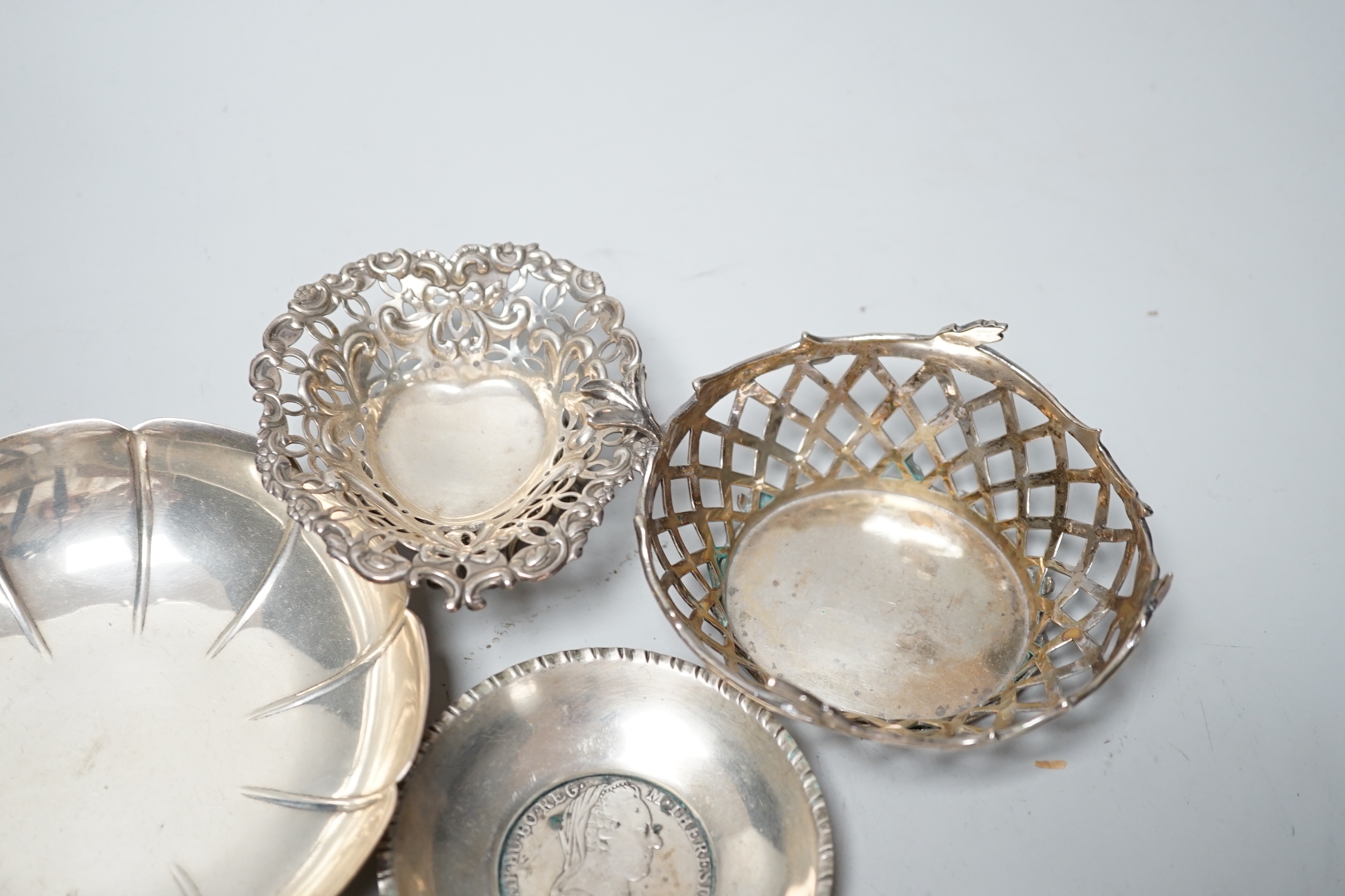 A modern pair of small silver mounted coasters, diameter 79mm, seven other silver or white metal dishes including Dutch and a small silver cream jug.